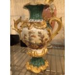 Twin handled Royal Worcester green ground vase decorated with hand painted village and floral