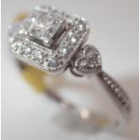 14ct white gold fancy diamond cluster ring with a central Princess cut diamond approximately 0.