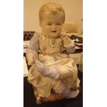 Antique continental bisque fired molded ceramic seated child figurine H: 30 cm CONDITION