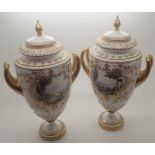 Pair of Royal Worcester vases and covers decorated with landscape panels reserved against a white