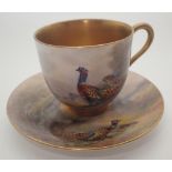 Royal Worcester gilded demi-tasse cup and saucer decorated with pheasants signed Jas Stinton c1922