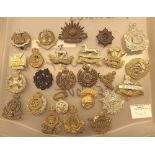 Twenty five military cap badges