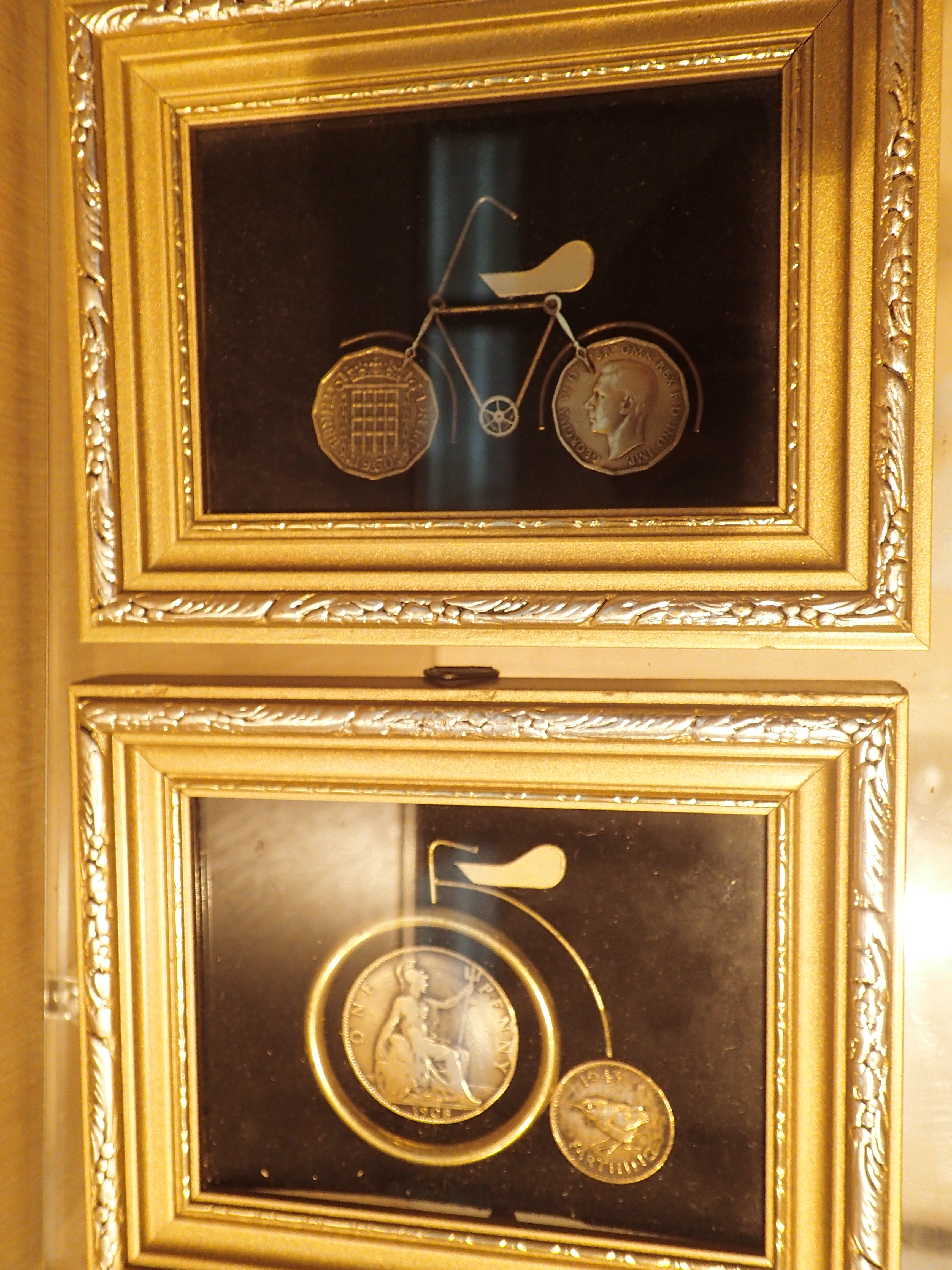 Two small framed cycle pictures made of coins one penny farthing and one threepenny piece cycle