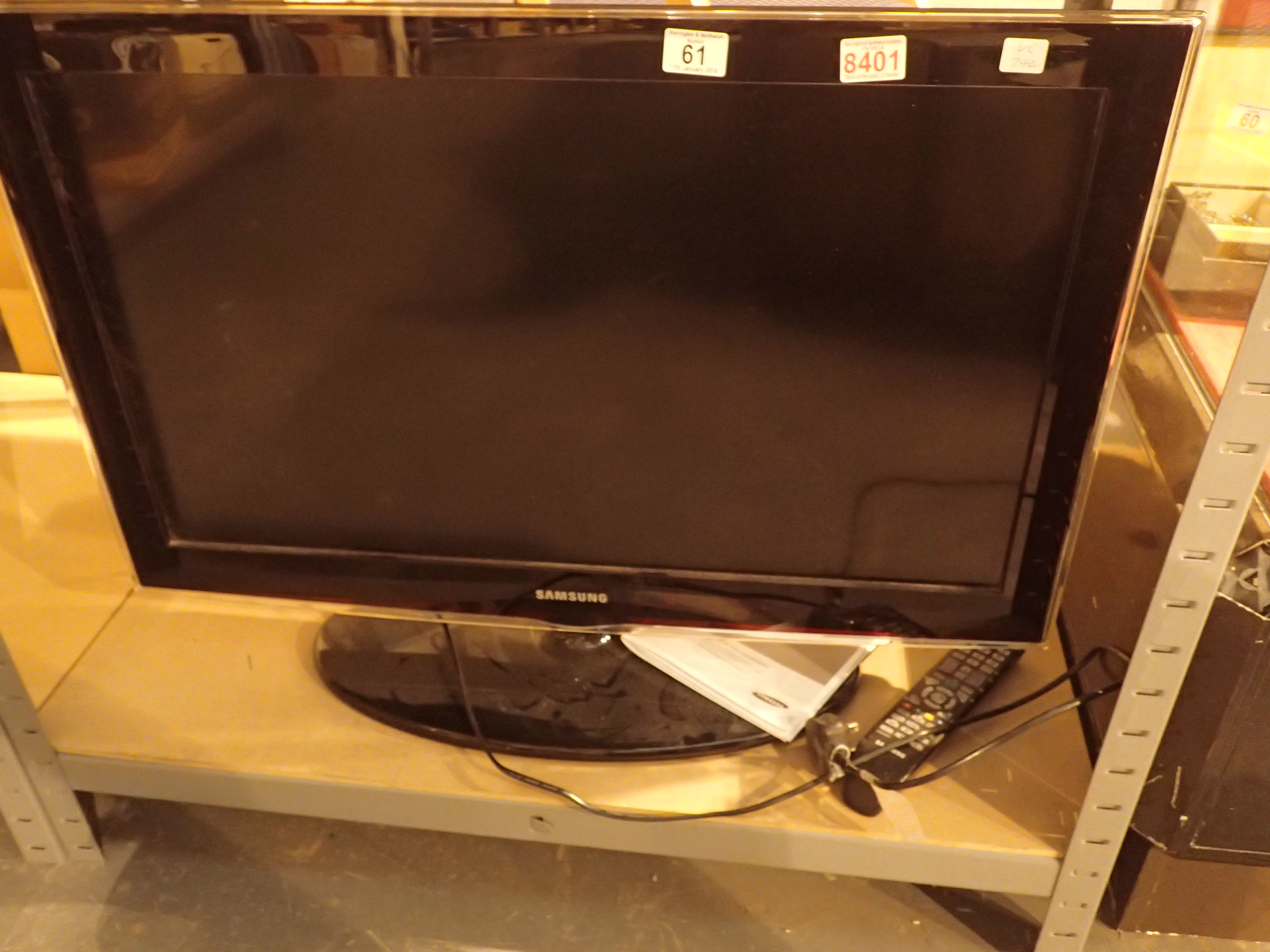 Samsung LCD TV with remote control and instruction book