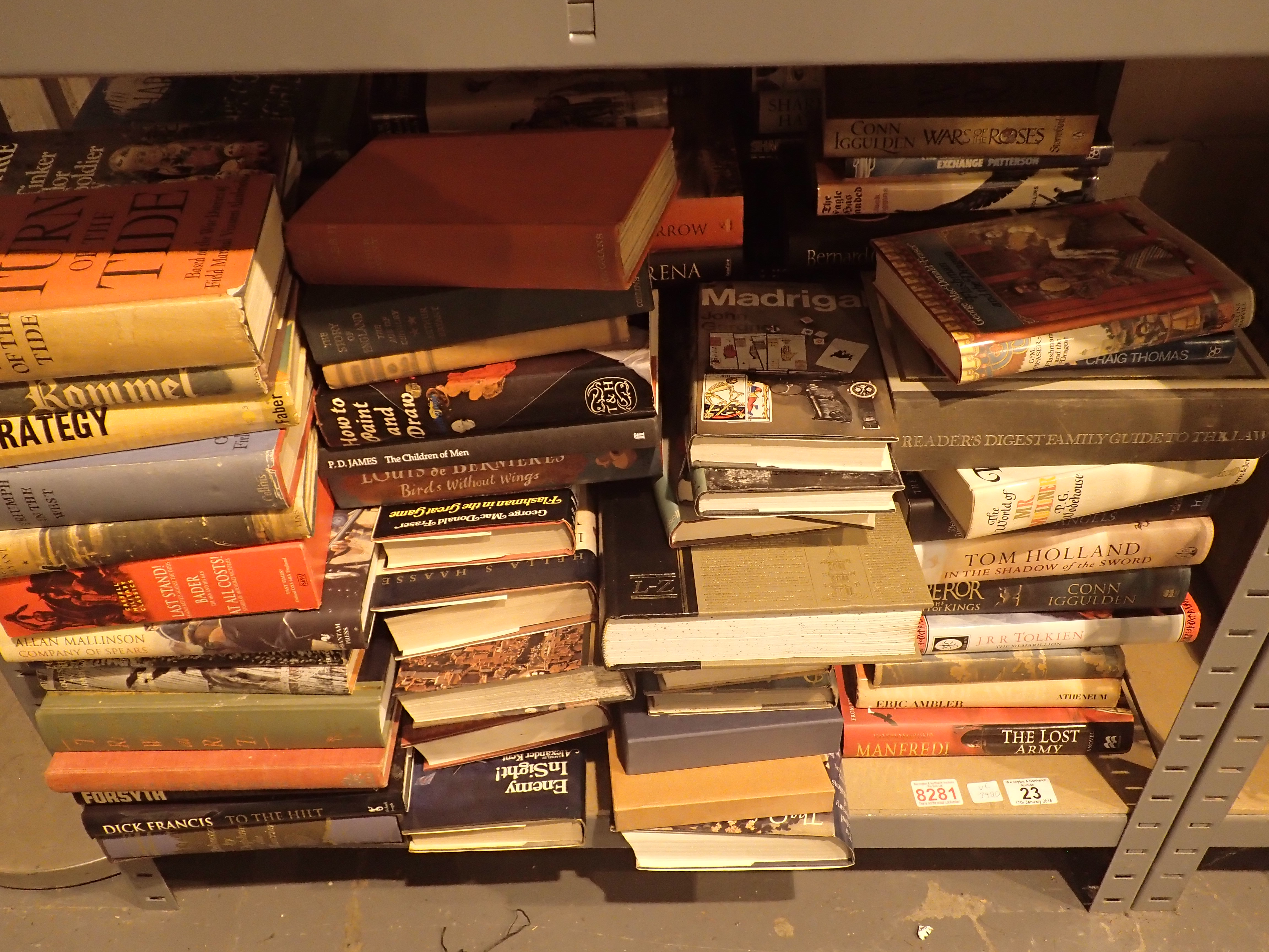 Shelf of assorted fact and fiction books mostly hardback