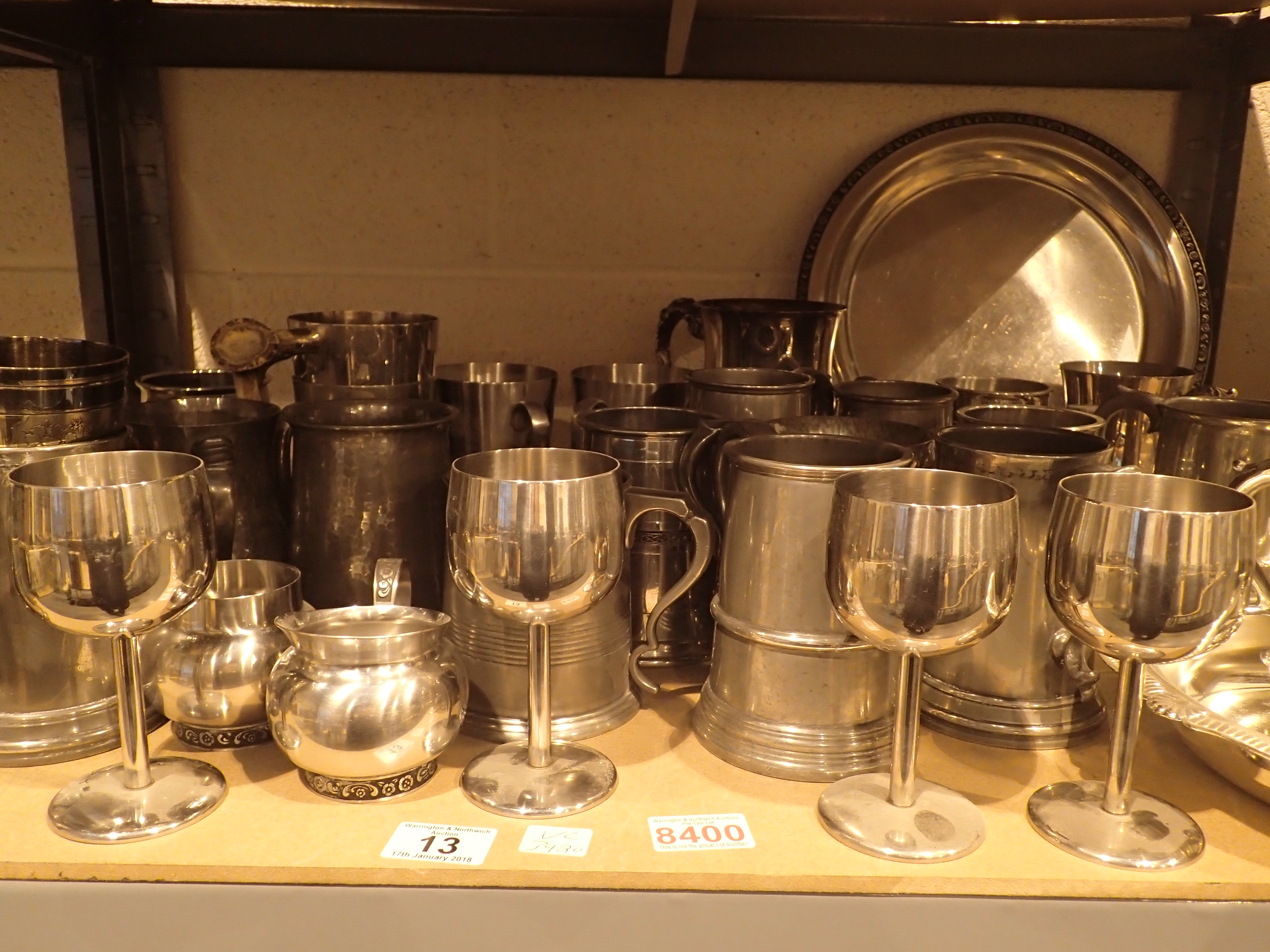 Shelf of mixed tankards goblets trays plate etc