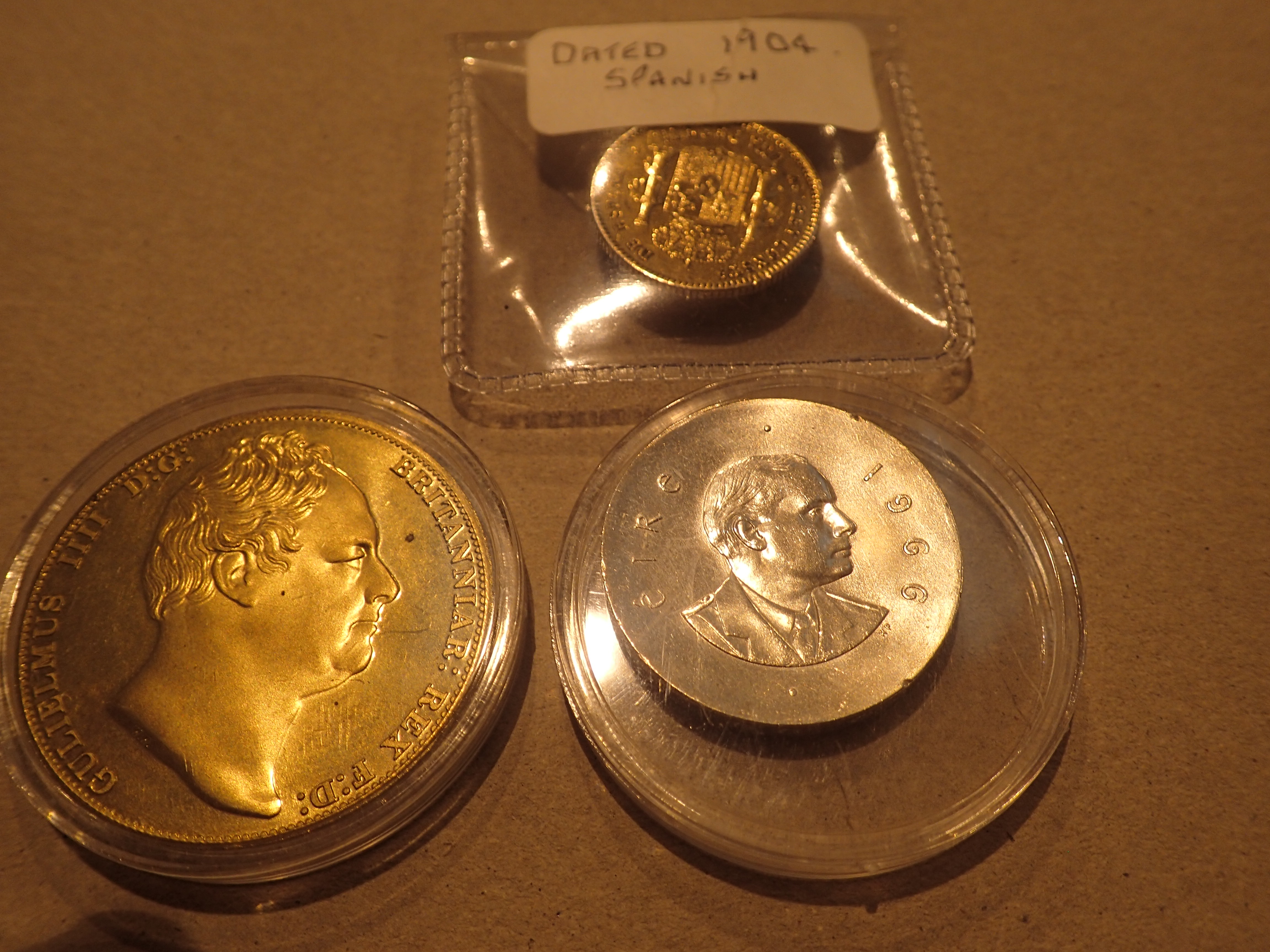 Three coins to include a silver Irish shilling and 1904 Peseta made as a badge and a Ceylon 1830