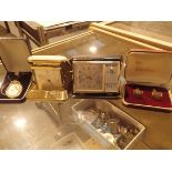 Two mechanical travelling alarm clocks a box of cufflinks and a boxed pendant