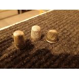 Three white metal thimbles including fingernail example