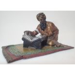 Believed Bergman cold painted bronze of an Arab man on a carpet reading reading a book 10 x 6 cm