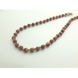 Single strand gold fleck hardstone necklace with 9ct gold clasp,