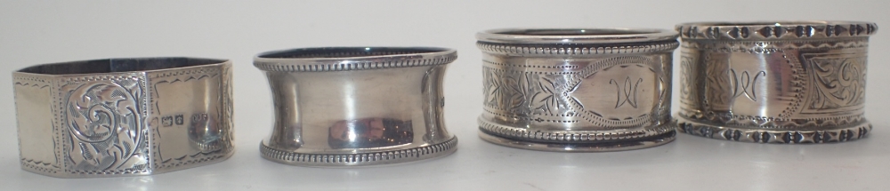 Four hallmarked silver napkin rings various assays