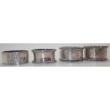 Four hallmarked silver napkin rings various assays