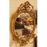 Georgian plaster gilt oval mirror with twin candle holders