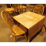 Ercol splay leg dropleaf table with two Ercol stickback chairs