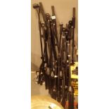 Eight black tubular steel adjustable free standing microphone stands