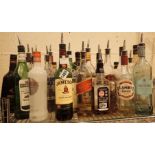 Large collection of mixed spirits and mixers all opened most with stainless steel dispensers