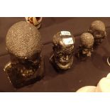 Four vintage African stone sculptured heads one with Tinapi to base tallest H: 29 cm