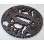 18thC Japanese iron tsuba with fine dragon decoration signed H: 6.