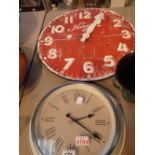 Two wall clocks one red and white open face D: 50 cm and one tin cream D: 35 cm