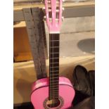 Pink acoustic guitar with case