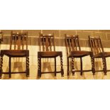 Four oak dining chairs with loose seat pads and barleytwist front legs