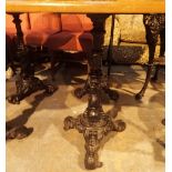 Pair of matching cast iron based single pedestal three footed pub tables with matching square