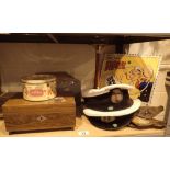 Shelf of mixed items including boxes and Royal Navy caps