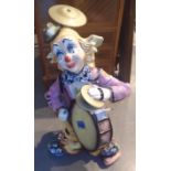 Large ceramic clown one man band H: 110cm CONDITION REPORT: Some slight damages