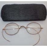 Vintage spectacle case containing yellow metal spectacles