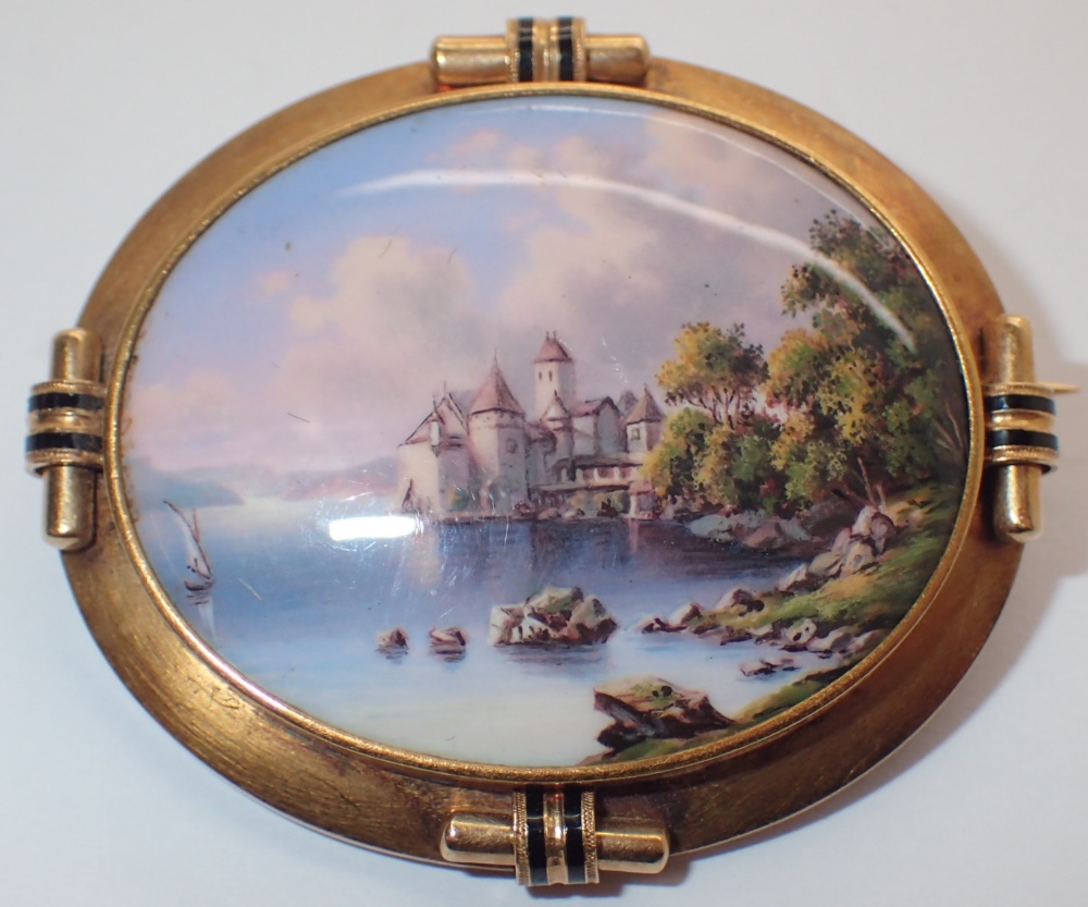 Victorian yellow metal brooch with central hand painted Swiss lake and castle scene ceramic panel