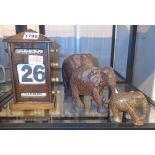 Oak cased perpetual calendar and three wooden elephants CONDITION REPORT: The