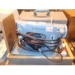 Singer electric sewing machine in green carry case