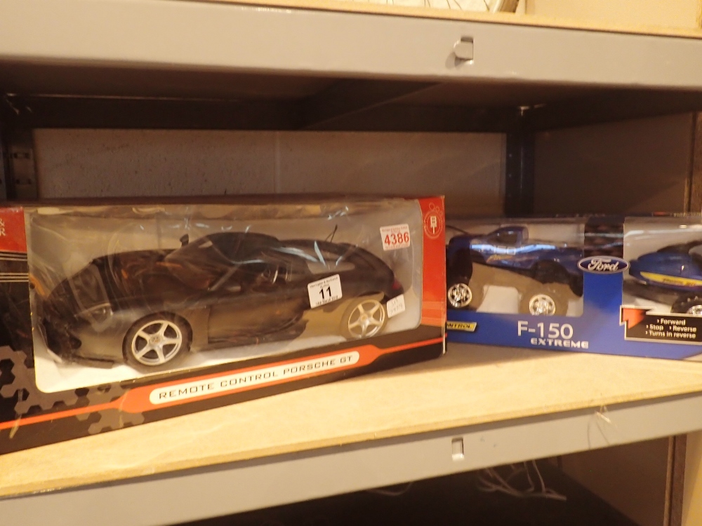 Remote controlled Porsche GT and remote controlled Ford F150 and jetski both boxed