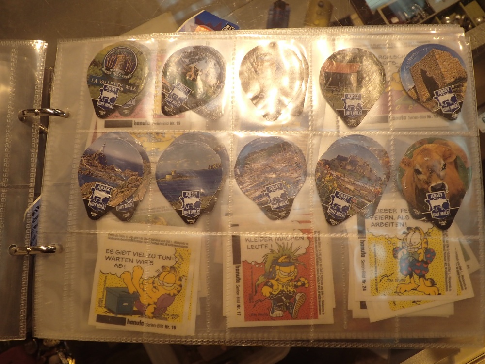 Album containing Disney tokens and Stockport interest cards and others