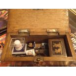 Wooden box with thimble and spoon contents