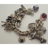 Heavy silver charm bracelet with mostly silver charms 91g