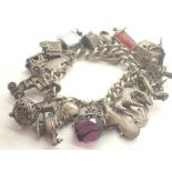 Heavy silver charm bracelet with mostly silver charms 138g