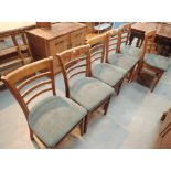 Set of six ladder back chairs with green upholstered seats