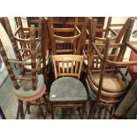 Nine tall wood framed pub stools with backs and upholstered seats and two tall stools H: 76 cm