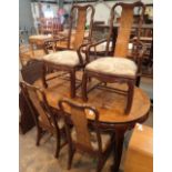 Chinese extending dining table with four chairs including two carvers