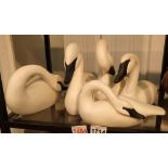Four wooden swans by James Waddon