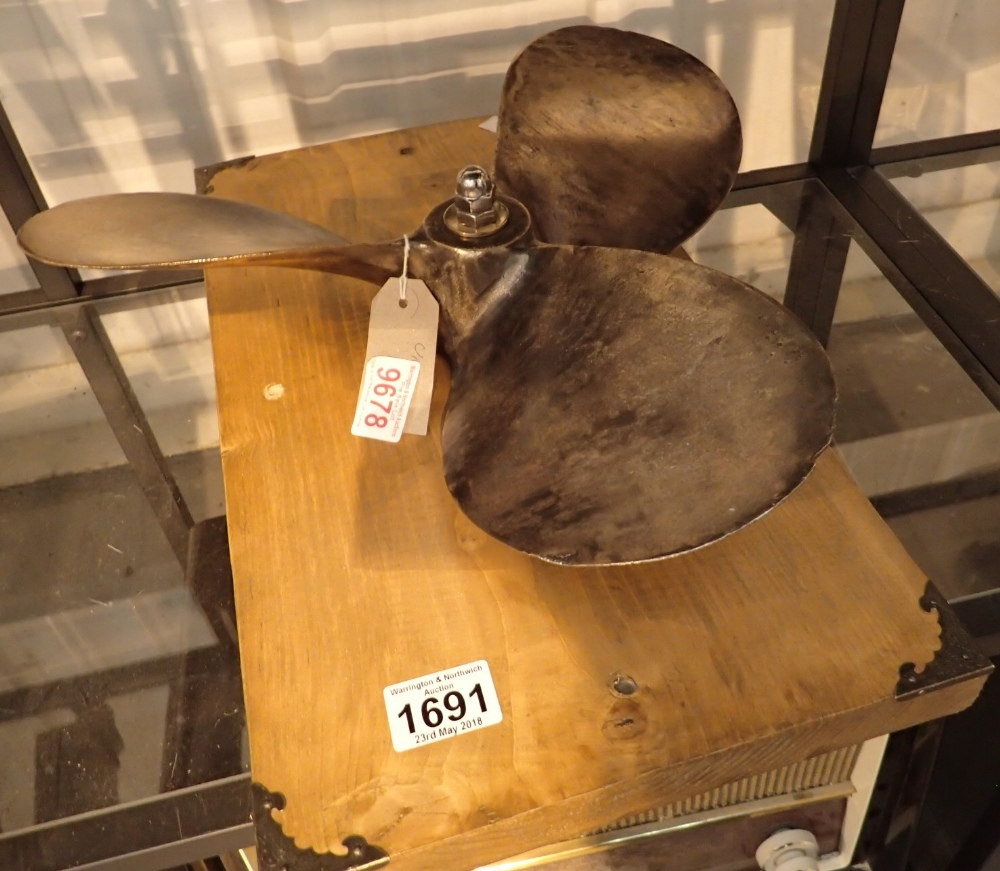 Bronze propeller mounted on a woode base