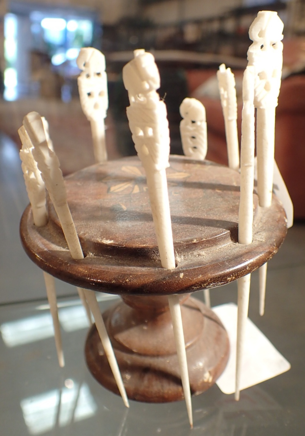 Carved bone cocktail sticks on an inlaid wooden base