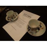 Nanking Cargo pair of teacups with elaborate loop handle and saucers with blue Chrysanthemum Rock