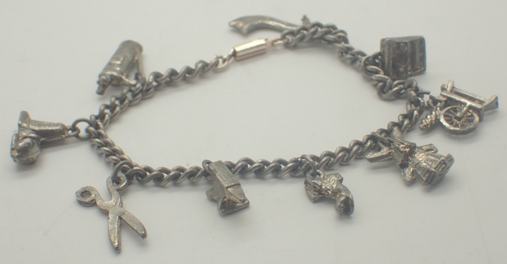 Silver charm bracelet with ten charms and padlock clasp