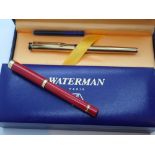 Two boxed Waterman fountain pens one with 18ct gold nib other red enamel finish