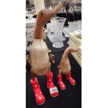 Two wooden ducks in wellington boots H: 44 cm