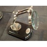 Chrome magnifying glass on wooden stand