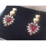 Pair of 9ct gold earrings with red heart